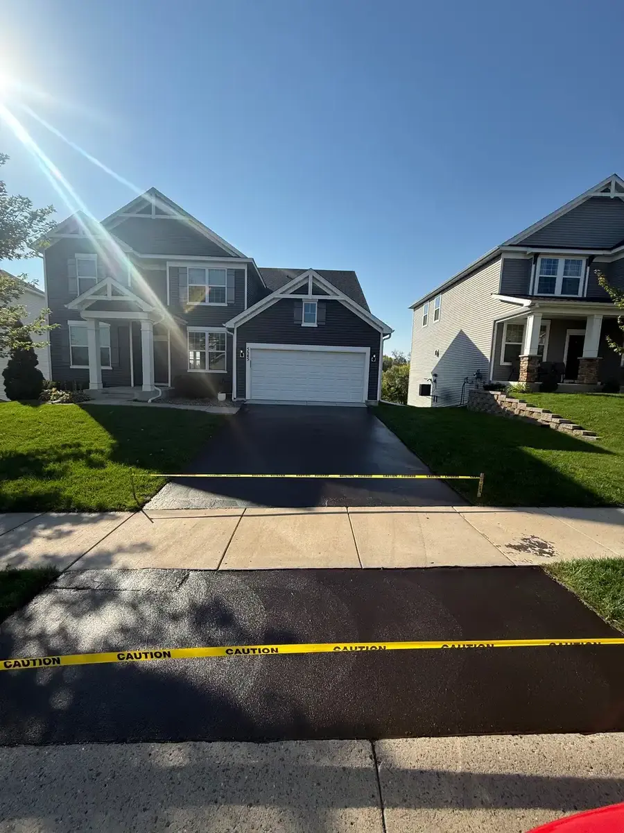 New asphalt driveway with concrete apron